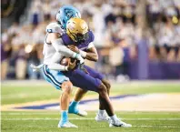  ?? MIKE CAUDILL/AP ?? Old Dominion linebacker Jason Henderson, shown sacking James Madison quarterbac­k Jordan McCloud, is 27 tackles shy of the FBS single-season record of 193.