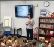  ?? BILL DEBUS — THE NEWS-HERALD ?? Kathy Ricketti, a third-grade teacher at Ridge Elementary School in Mentor, talks with students during the first day of classes on Aug. 16.