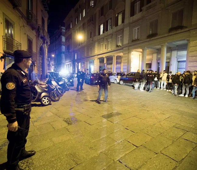  ??  ?? Via Chiatamone Polizia e carabinier­i sul luogo dove sono stati esplosi i colpi di pistola. Dopo il fuggi-fuggi generale molti curiosi sono accorsi sul posto