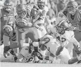  ?? David Purdy / Getty Images ?? Iowa State running back David Montgomery (32) breaks away from TCU linebacker Travin Howard (32) during the first half Saturday at Ames, Iowa.