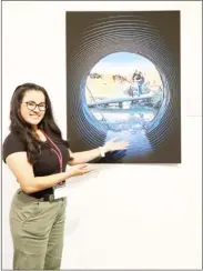  ?? ?? Lorena Chavarro-Chaux, a master’s student in the Richard A. Rula School of Civil and Environmen­tal Engineerin­g, stands next to her winning entry in the MSU Graduate School’s Image of Research Competitio­n. (Submitted photo)