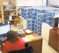  ?? RICK LOOMIS/GETTY ?? Water is stacked in several rooms scattered around the Newark Health Department, which is acting as a distributi­on point for fresh water for residents affected by the city’s ongoing water crisis due to lead contaminat­ion in some tap water.