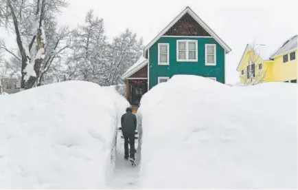  ?? Photos by Helen H. Richardson, The Denver Post ?? John Hess did maintenanc­e shoveling a few times a day in the tunneled path toward his home as the flakes continued to pile up in 2017 during the snowiest January ever in Crested Butte.