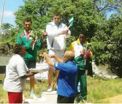  ??  ?? Akinyemi (middle) collects his 2015 African champion medal in Kenya