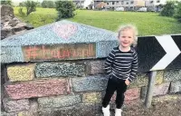  ??  ?? A family are showing their support for key workers by colouring in the brick wall along Rising Bridge Road. Pictured is Taya, five