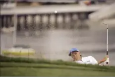  ?? AP photos ?? TOP PHOTO: Rickie Fowler hits out of a bunker on the sixth hole Thursday. LEFT
Tiger Woods reacts after his tee shot on the fifth hole — his hooked shot led to a double bogey.