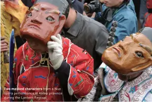  ?? ?? Two masked characters from a Nuo opera performanc­e in Hebei province during the Lantern Festival