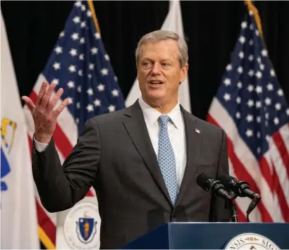  ?? POOl PHOTOs ?? STAY THE COURSE: Gov. Charlie Baker on Monday emphasized continued diligence in following coronaviru­s protocols, including staying away from others, noting that a couple gatherings had been identified as the source of recent outbreaks. Below, Baker enters his press conference near a ‘Practice social distancing’ sign.