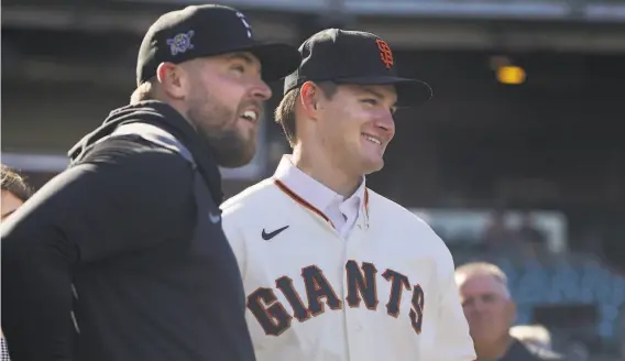  ?? Jeff Chiu / Associated Press ?? Pittsburgh Pirates pitcher David Bednar (left) talks with his brother, San Francisco Giants firstround draft pick Will Bednar, before Friday’s game.