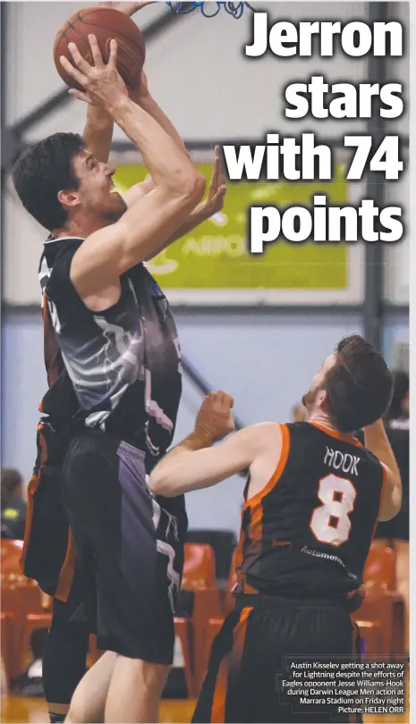  ?? Picture: HELEN ORR ?? Austin Kisselev getting a shot away for Lightning despite the efforts of Eagles opponent Jesse Williams-Hook during Darwin League Men action at Marrara Stadium on Friday night