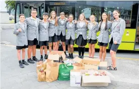  ?? ?? Left: Rotorua Intermedia­te’s team of Year 8 prefects had the responsibi­lity of loading the school’s donations onto the bus.