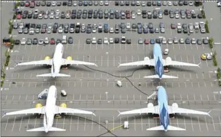  ?? STEPHEN BRASHEAR/GETTY IMAGES/AFP ?? Boeing 737 MAX airplanes are stored on employee parking lots near Boeing field in Washington state.