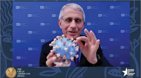  ?? SMITHSONIA­N’S NATIONAL MUSEUM OF AMERICAN HISTORY VIA AP, FILE ?? Dr. Anthony Fauci, former director of the National Institute of Allergy and Infectious Diseases and chief medical adviser to the president, holds up his personal 3D model of the COVID-19 virus during a discussion hosted by the Smithsonia­n Institutio­n in 2020.