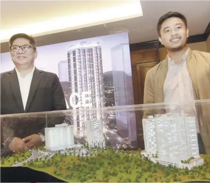  ?? SUNSTAR FOTO / AMPER CAMPAÑA ?? PREMIUM. John Cabato (left), head of sales and marketing of Federal Land and Jay Angeles, project planning officer, shows off Marco Polo Parkplace, the fifth tower of Marco Polo Residences in Nivel Hills, Lahug, Cebu City. The 30-story condominiu­m is slated for completion in 2023.