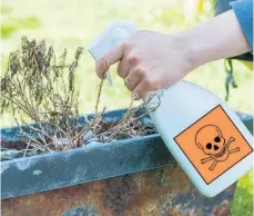  ?? Picture / Getty Images ?? In some countries, citizen gardeners are warned to hand-weed to be on the safe side.