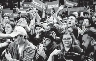  ?? Elizabeth Conley / Staff file photo ?? Attendees of a Bernie Sanders rally try to shake hands with the candidate last weekend. A University of Houston and Univision poll shows Sanders with a slight lead in the Texas primary.