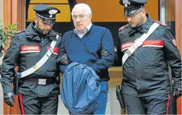  ?? Picture: AFP ?? MAJOR SWOOP: Settimino Mineo, jeweller and new head of the Sicilian mafia, is escorted by police after his arrest. Police also swooped on dozens of other suspects in Sicily in a major coup