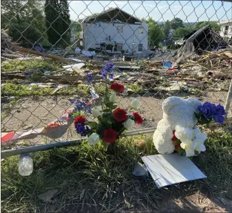  ?? EVEN BRANDT — MEDIANEWS GROUP ?? Flowers and a teddy wear mark the site of Thursday’s home explosion on Hale Street which killed five, including four children, and injured two more.