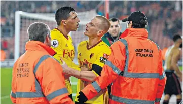  ??  ?? Bitter end: Watford’s Ben Watson tries to calm team-mate Jose Holebas as he remonstrat­es with their team’s fans at full-time