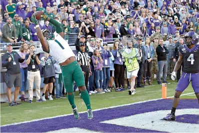  ?? AP Photo/Ron Jenkins ?? ■ Baylor cornerback Grayland Arnold (1) intercepts the ball as TCU safety Keenan Reed (4) looks on to end the game in the third overtime of an NCAA college football game Saturday in Fort Worth, Texas. Baylor won, 29-23, in triple overtime.