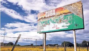  ?? SUSAN MONTOYA BRYAN/ THE ASSOCIATED PRESS ?? A faded billboard in July at the edge of Cuba advertises the area’s natural amenities and tourist destinatio­ns.