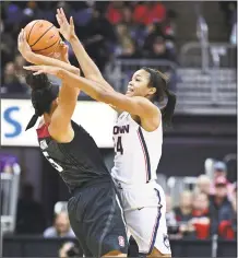  ?? David Dermer / Associated Press ?? Stanford's Kaylee Johnson, left, is pressured by UConn’s Napheesa Collier during Sunday’s game in Columbus, Ohio.