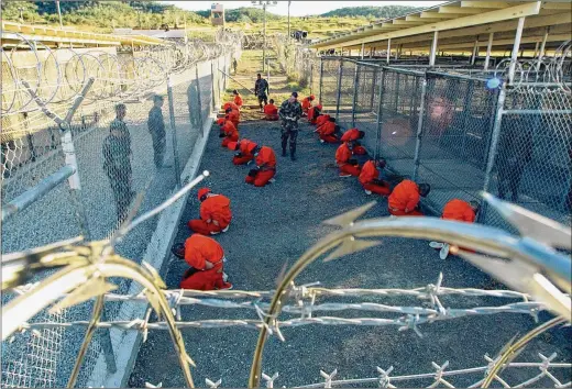  ?? U.S. NAVY VIA THE NEW YORK TIMES ?? Shane T. Mccoy’s photo of Jan. 11, 2002, shows the first 20 prisoners at Guantánamo Bay, Cuba, soon after their arrival. How you view the photo depends on “your politics, your awareness of Guantánamo and what went on there,” says Anne Wilkes Tucker, a former curator of photograph­y at a Houston museum.