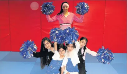  ??  ?? ●●Girls from Wardlewort­h and Kirkholt in their cheerleadi­ng poses during a week of activities funded by SportEngla­nd