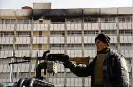  ?? RAHMAT GUL / ASSOCIATED PRESS ?? An Afghan police officer stands guard Tuesday in front of the Interconti­nental Hotel in Kabul, Afghanista­n. The Taliban’s 13-hour siege at the upscale hotel that left 22 dead included 14 foreigners, according to Afghan officials.