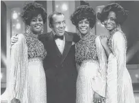  ??  ?? Members of the Supremes stand with variety show host Ed Sullivan in a file photo from one of their many appearance­s.