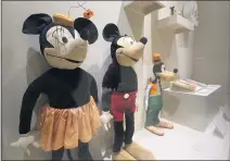  ?? PAUL BERSEBACH — STAFF PHOTOGRAPH­ER ?? Minnie Mouse, Mickey Mouse and Goofy dolls from the 1930s are part of exhibition “Inside the Walt Disney Archives” at the Bowers Museum.