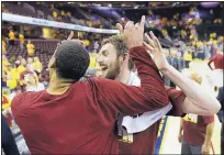  ?? TONY DEJAK/ASSOCIATED PRESS ?? Cleveland’s Kevin Love, center, and Channing Frye celebrate after the Cavaliers routed the Toronto Raptors on Wednesday night.
