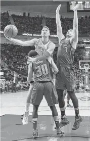  ?? Eric Christian Smith / Associated Press ?? Rockets forward Sam Dekker runs into Mavericks guard Seth Curry while driving to the basket past Dallas forward Dwight Powell, right, during the first half. Dekker had nine points in 23 minutes.