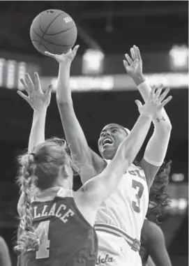  ?? Michael Owen Baker, The Associated Press ?? UCLA guard Jordin Canada (3) shoots over Baylor’s Kristy Wallace during the first half Saturday in Los Angeles. No. 8 UCLA defeated third-ranked Baylor 8268.