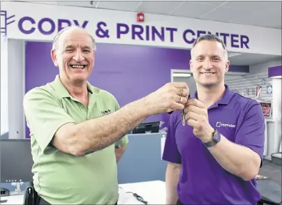  ?? MILLICENT MCKAY/JOURNAL PIONEER ?? Henri Gallant, left, hands the keys to the castle, or the family business, over to son Pierre the new owner of HMS Office Supplies Ltd.