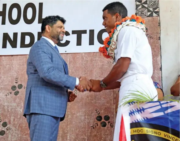  ?? Photo: Kelera Sovasiga ?? Chief guest Attorney-General Aiyaz Sayed-Khaiyum congratula­tes Marist Brothers High School head boy Joshua Lewenilovo during the school’s prefects induction ceremony on February 6, 2020 at Lambert Hall in Flagstaff, Suva.