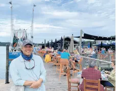  ?? PHILIP POTEMPA/POST-TRIBUNE ?? Andrew Carmines, owner of Hudson’s on the Docks on Hilton Head Island, South Carolina, pauses along its waterfront dining stretch in October.
