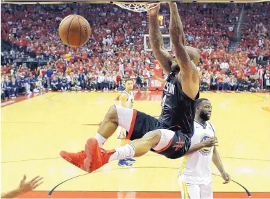  ?? DAVID J. PHILLIP/ASSOCIATED PRESS ?? Houston’s P.J. Tucker (4) throws down a dunk in front of Golden State’s Draymond Green during the Rockets’ win over the Warriors in Game 2 of the Western Conference Finals Wednesday in Houston.