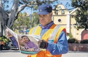  ?? Ricardo DeAratanha Los Angeles Times ?? BUS OPERATOR Jesus Barraza reads informatio­n about the Covered California healthcare marketplac­e at Plaza Kiosko in Los Angeles in March 2014. This year’s open enrollment period is from Nov. 1 to Jan. 31, 2018.