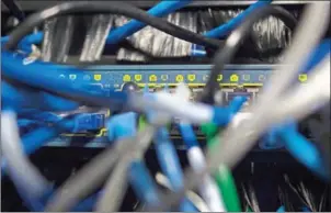  ?? ANDREW CABALLERO-REYNOLDS/AFP ?? Network cables are seen going into a server in an office building in Washington, DC, on Saturday. The ‘WannaCry’ ransomware attack hit hard in China, where estimates say 70 percent of computers run unlicensed software.
