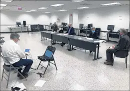  ?? TED SLOWIK/DAILY SOUTHTOWN ?? A stenograph­er records proceeding­s as James Nally, right, legal counsel for the Cook County clerk, advises the three-member Cook County Officers Electoral Board on Tuesday at the Cook County Administra­tion Building in Chicago.