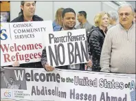  ?? AP PHOTO ?? Refugee supporters look on after Abdisellam Hassen Ahmed, a Somali refugee who had been stuck in limbo after President Donald Trump temporaril­y banned refugee entries, arrival at Salt Lake Internatio­nal Airport, Friday.