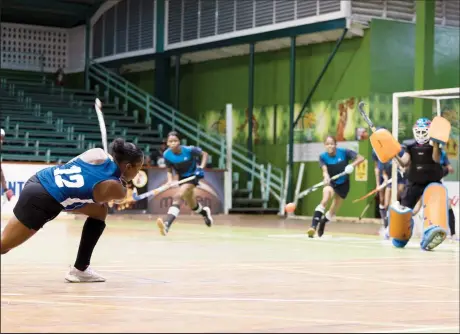  ?? ?? Abosaide Cadogan of GCC Roulette in the process of scoring from a penalty corner against Saints in the ExxonMobil National Indoor Hockey Championsh­ips