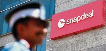  ??  ?? Merger talks: A private security gurad stands at Snapdeal headquarte­rs in Gurugram on the outskirts of New Delhi. Flipkart and Snapdeal have been in merger talks since April. — Reuters