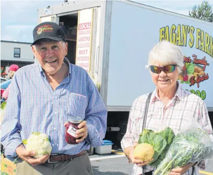  ?? BARB SWEET/THE TELEGRAM ?? Bill and Patricia Collins have been buying vegetables for decades at Churchill Square’s open-air market.