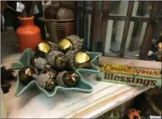  ?? CAROL HARPER — THE MORNING JOURNAL ?? Acorns crafted from sleigh bells add a whimsical touch to fall decorating items at Zelek Flower Shop at 1001 Reid Ave. in Lorain.