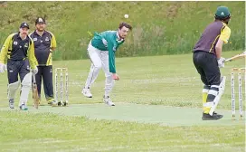  ??  ?? Right - Jarryd Bain bowls for Iona in the C Grade clash against Jindivick as rain loomed all afternoon.