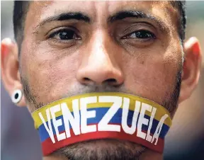  ?? AP ?? An anti-government protester covers his mouth during a 12-hour national sit-in, in Caracas, Venezuela, in this June 5, 2017 photo.