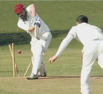  ??  ?? Murton batsman Gavin Milne is bowled out by Marsden bowler Steven Nielsen.