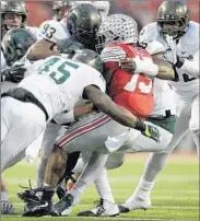  ?? JAY LAPRETE/AP ?? Michigan State defenders swallow up Ohio State running back Ezekiel Elliott during the Spartans’ win on Saturday.